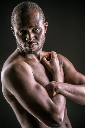 Handsome muscular african american man. Over black background.の写真素材