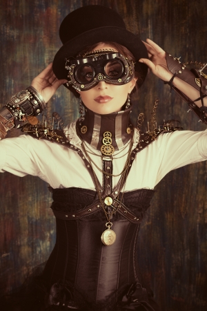 Portrait of a beautiful steampunk woman over grunge background.の写真素材