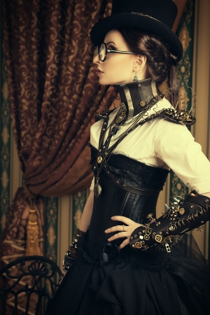 Portrait of a beautiful steampunk woman over vintage background.の写真素材