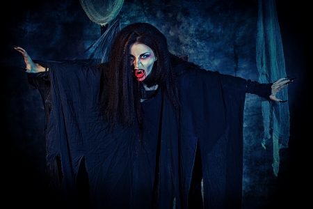Bloodthirsty vampire flying at the night cemetery in the mist and moonlight.の写真素材