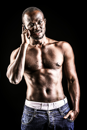Handsome muscular african american man. Over black background.の写真素材