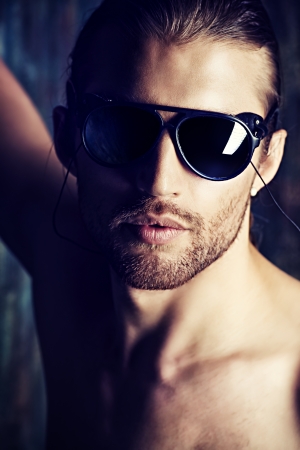 Sexual muscular man posing over isolated on darkの写真素材