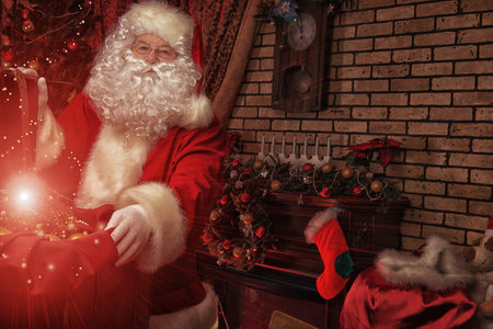 Santa Claus at home preparing for Christmas gifts.の写真素材