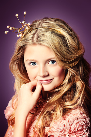 Portrait of a beautiful girl who looks like a little princess with a crown on her head.の写真素材