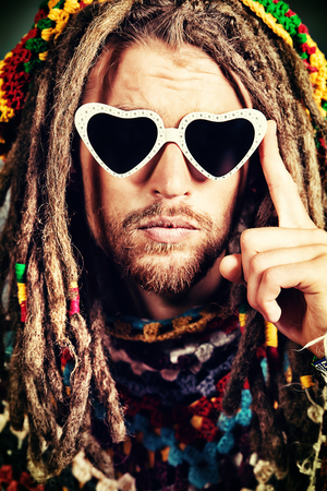 Portrait of a hippie young man in spectacles.の写真素材