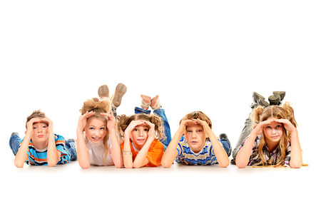 Group of children curiously looking into the distance. Isolated over white.の写真素材