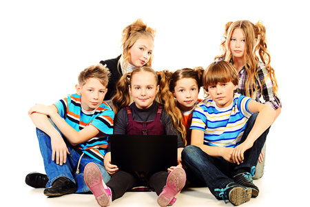 Group of schoolboys and girls sitting with laptop. Isolated over white.の写真素材