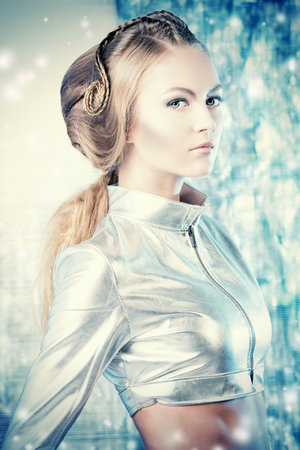 Close-up portrait of a beautiful young woman in silver latex costume with futuristic hairstyle and make-up. Sci-fi style.の写真素材