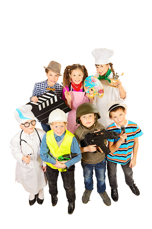A group of children dressed in costumes of different professions. Isolated over white.の写真素材