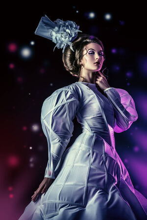 Portrait of a beautiful fashion model in the refined white dress and elegant hat. の写真素材