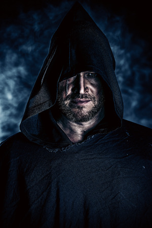 Portrait of a courageous warrior wanderer in a black cloak. Historical fantasy. Halloween.の写真素材