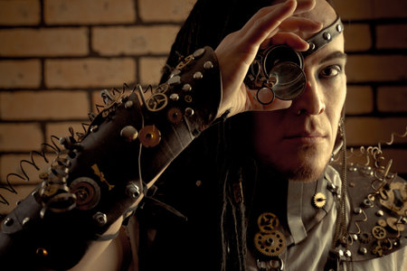 Portrait of a steampunk man with a mechanical devices over brick wall.