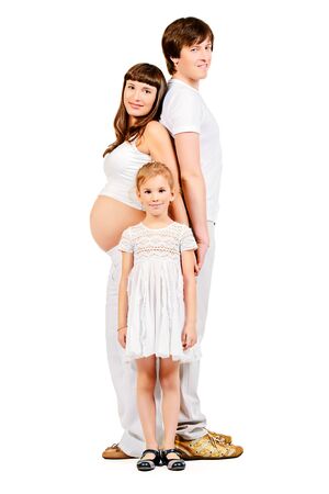 Happy family expecting one more baby. Full length portrait. Isolated over white.の写真素材