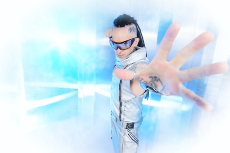 Portrait of the eccentric futuristic man in silver costume. Innovations and high technology. Rock artist.の写真素材