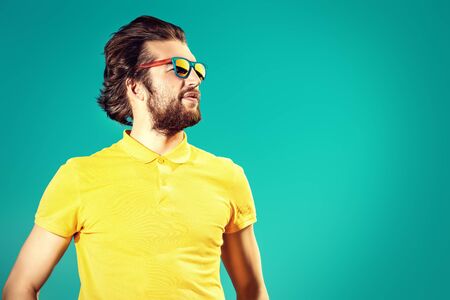 Handsome young man over blue sky. Summer rest, vacation.の写真素材