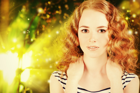 Portrait of a pretty red-haired girl teenager smiling at camera. の写真素材