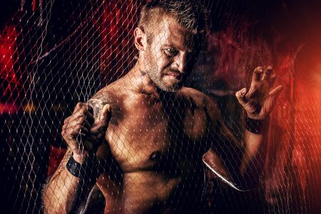 Handsome muscular man in the old garage.の写真素材