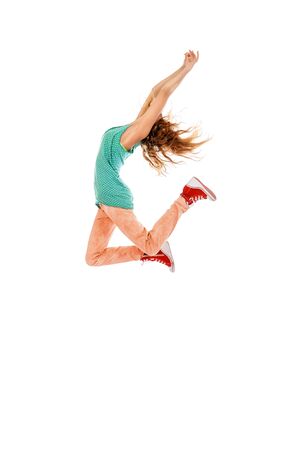 Happy girl jumping for joy. Success. Isolated over white.の写真素材