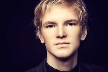 Portrait of a calm handsome young man looking at camera. の写真素材