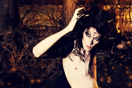 Close-up portrait of a fantasy man in a wild wood. Art project. Fantasy. Halloween.