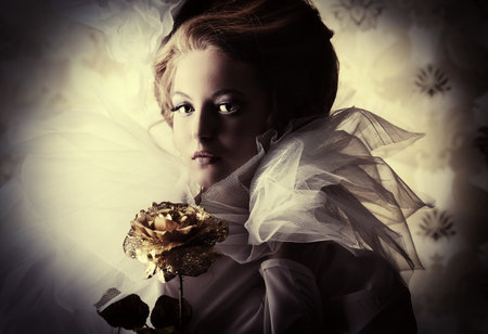 Beautiful fashion model in the refined white dress and elegant hat. Vintage style. Art project.の写真素材