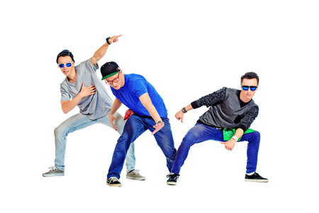 Three modern dancers at studio. Isolated over white.