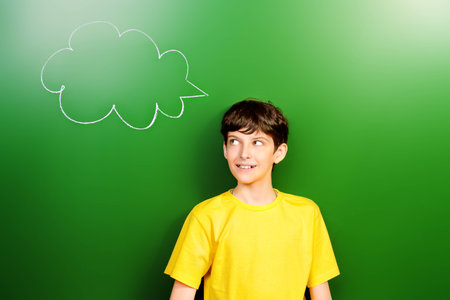 Smart schoolboy stands at the blackboard in the classroom. Education. New idea.の写真素材