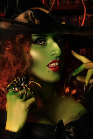 Close-up portrait of a fairy wicked witch in the wizarding lair. Magic. Halloween.の写真素材