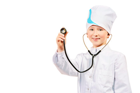 Pretty ten years girl dressed like a doctor posing at studio. Occupations. Isolated over white. の写真素材