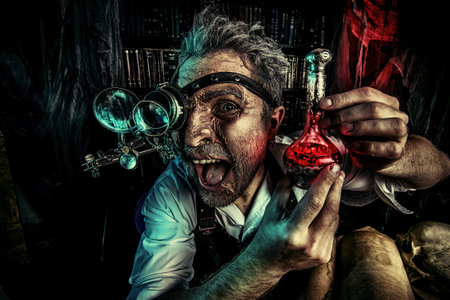 Portrait of a crazy medieval scientist working in his laboratory. Alchemist. Halloween.の写真素材