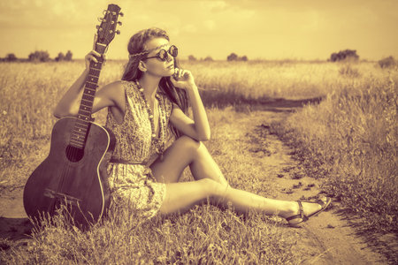 Romantic girl traveling with her guitarの写真素材