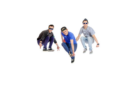 Three professional dancers dancing hip-hop at studio. Isolated over white.の写真素材