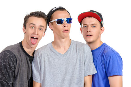 Three funny guys friends standing together. Different emotions. Isolated over white.の写真素材