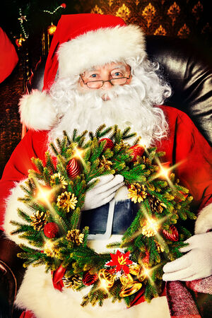 Santa Claus sitting at home with gifts, dressed in his home clothes. Christmas. Decoration.の写真素材