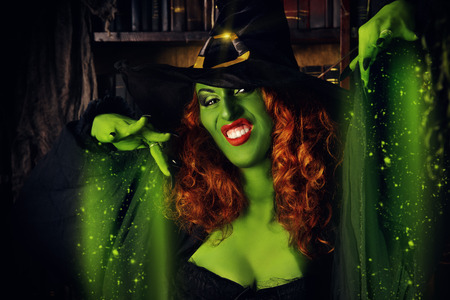 Close-up portrait of a fairy wicked witch in the wizarding lair. Magic. Halloween.の写真素材