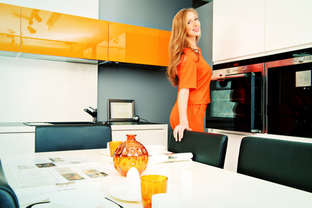 Happy young woman cooking in the kitchen at home. Healthy eating. Home interior. Furniture.の写真素材