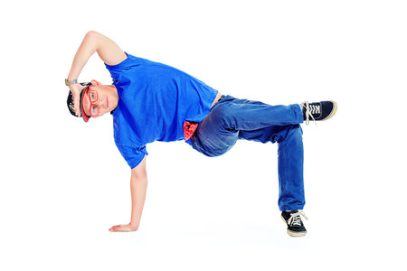 Professional young man dancer dancing hip-hop at studio. Isolated over white.