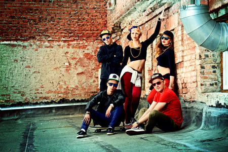 Group of young modern people posing together with fun. Urban lifestyle. Hip-hop generation.の写真素材