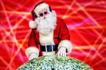 Santa Claus DJ near brilliant sparkling disco ballの写真素材