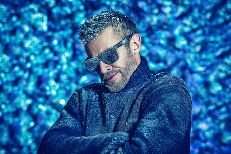 Portrait of a handsome brutal man dressed in winter clothes, covered with frost.の写真素材