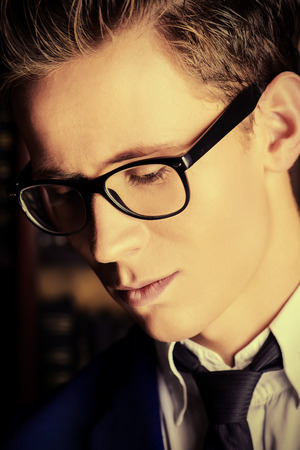Portrait of a handsome young man in elegant suit and spectacles.の写真素材