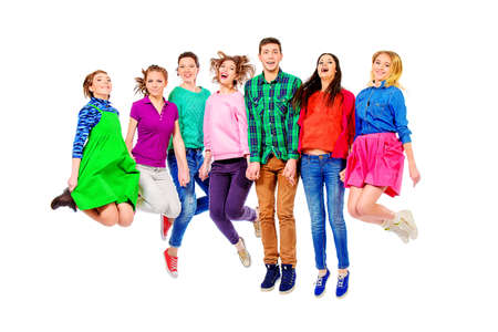 Large group of cheerful young people jumping for joy. Isolated over white.の写真素材