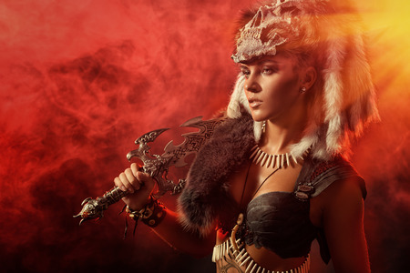 Beautiful bellicose Amazon with a sword in battle. Ancient times. Fantasy.の写真素材