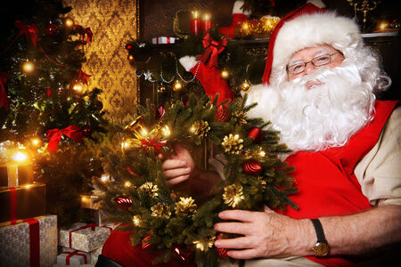Santa Claus sitting at home with gifts, dressed in his home clothes. Christmas. Decoration.の写真素材