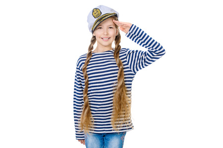 Joyful teen girl wearing sailor's striped vest and marine cap. Studio shot. Isolated over white.の写真素材