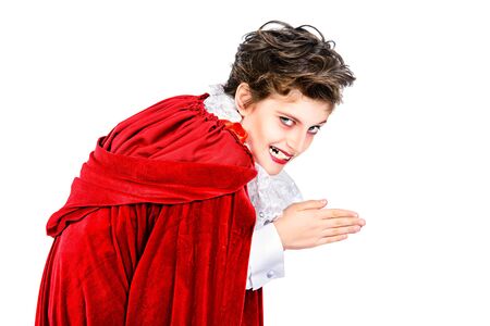 Expressive teen boy in a costume of vampire posing over white background.  Halloween. Isolated.の写真素材