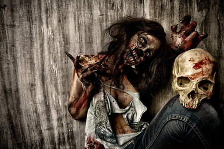 Frightening bloody zombie girl with a skull. Halloween.