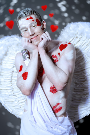 Portrait of a male Angel Cupid smiling at camera. Valentine's day. Love concept.の写真素材