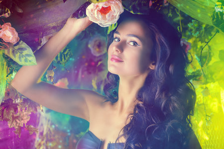 Beautiful brunette woman in bikini among tropical plants. Beauty, fashion. Spa, healthcare. Tropical vacation.の写真素材