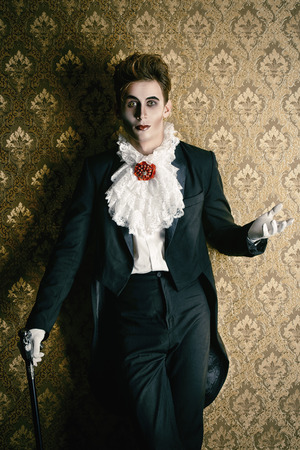 Portrait of a handsome male vampire over vintage backgroundの写真素材